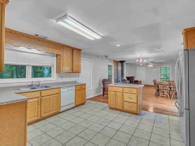 4978 Standifer Rd, Cohutta, GA 30710 - kitchen with white dishwasher, freestanding refrigerator, a sink, light tile patterned flooring, and open floor plan