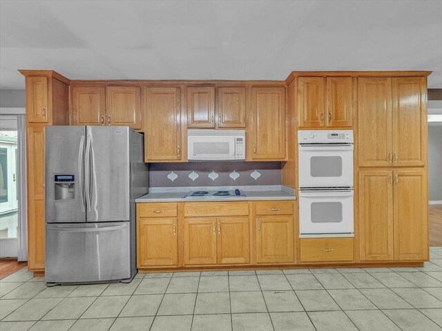 4978 Standifer Rd, Cohutta, GA 30710 - kitchen featuring white appliances, light countertops, brown cabinets, and light tile patterned floors