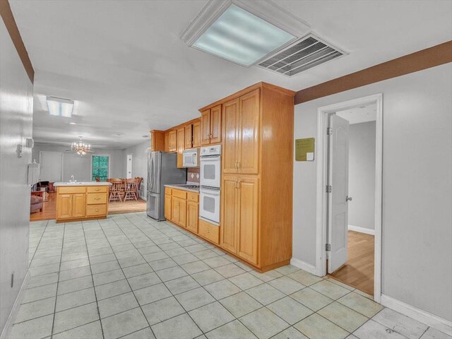 4978 Standifer Rd, Cohutta, GA 30710 - kitchen with white appliances, a chandelier, light tile patterned flooring, light countertops, and baseboards