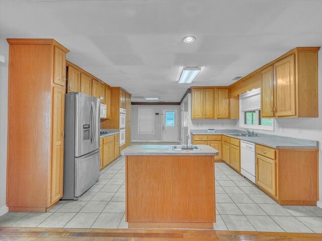 4978 Standifer Rd, Cohutta, GA 30710 - kitchen with white appliances, a sink, a center island, light countertops, and light tile patterned floors