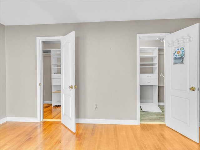 4978 Standifer Rd, Cohutta, GA 30710 - unfurnished bedroom with a walk in closet, a closet, light wood finished floors, and baseboards