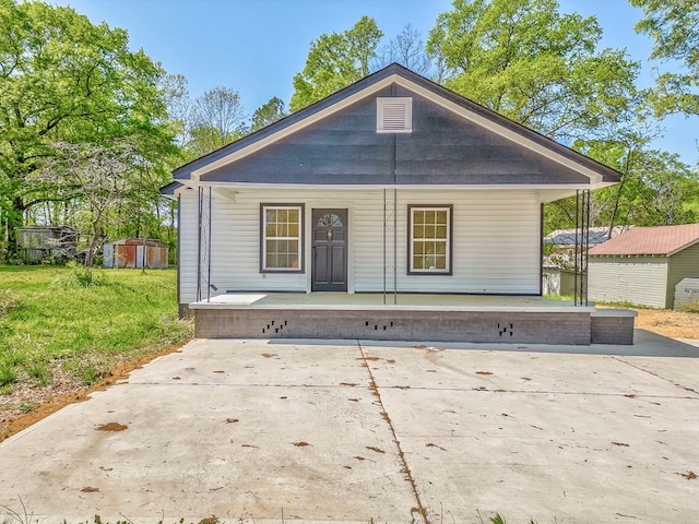 210 Grimes St, Dalton, GA 30721 - rear view of property with a porch, a yard, an outbuilding, and a storage shed