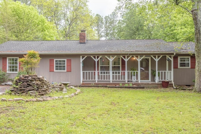 ranch-style house with a front yard, a porch, and a chimney