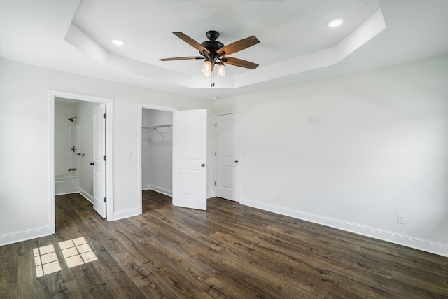 111 Arthur St, Dalton, GA 30721 - unfurnished bedroom featuring a tray ceiling, dark wood finished floors, baseboards, recessed lighting, and ensuite bath