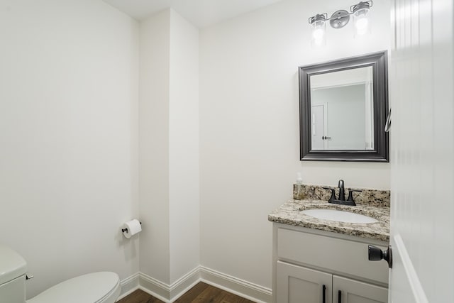 111 Arthur St, Dalton, GA 30721 - half bathroom featuring toilet, wood finished floors, vanity, and baseboards