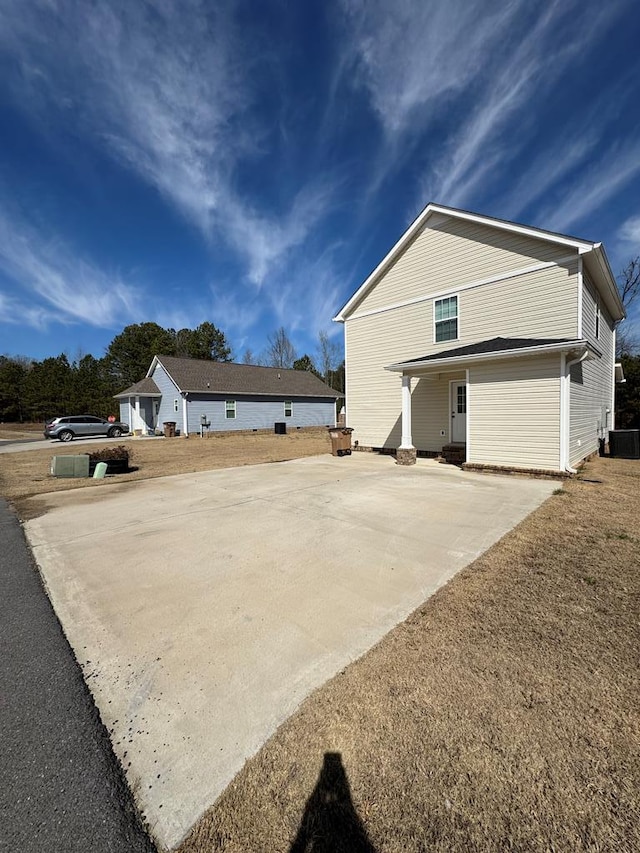 exterior space with cooling unit and driveway