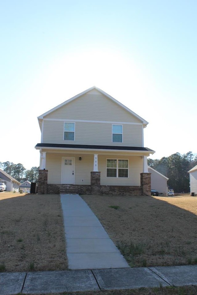 view of front of home with a porch and a front lawn