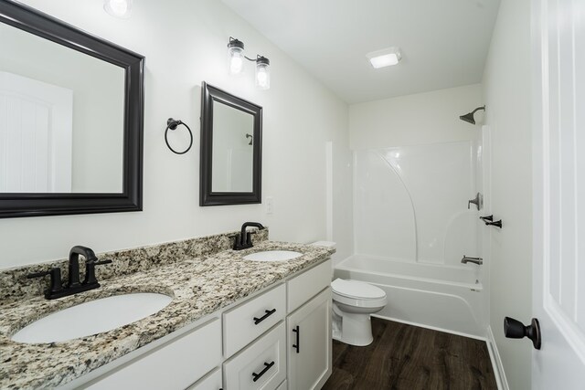 111 Arthur St, Dalton, GA 30721 - full bathroom featuring wood finished floors, toilet, double vanity, and shower / tub combination