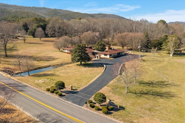 birds eye view of property featuring a water view, a view of trees, and a rural view