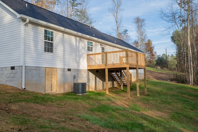 back of property featuring a deck, a yard, and central AC unit