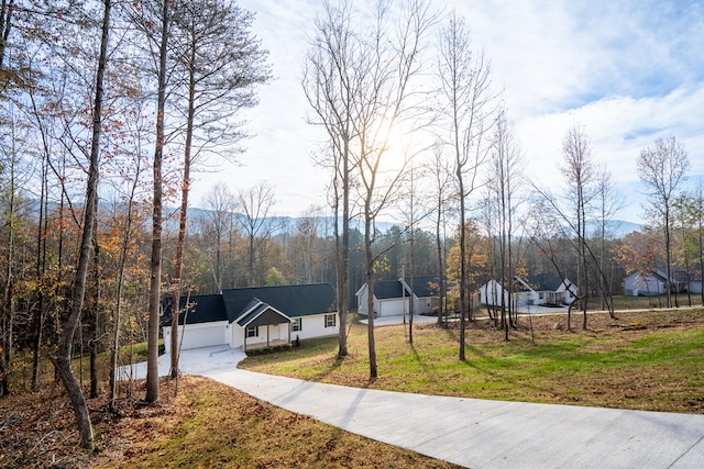 view of front of home with a garage and a front lawn