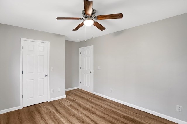 spare room featuring wood-type flooring and ceiling fan