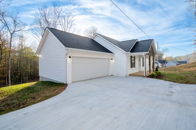 view of property exterior featuring a porch and a garage