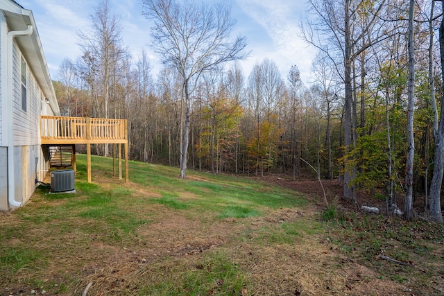 view of yard featuring cooling unit and a deck