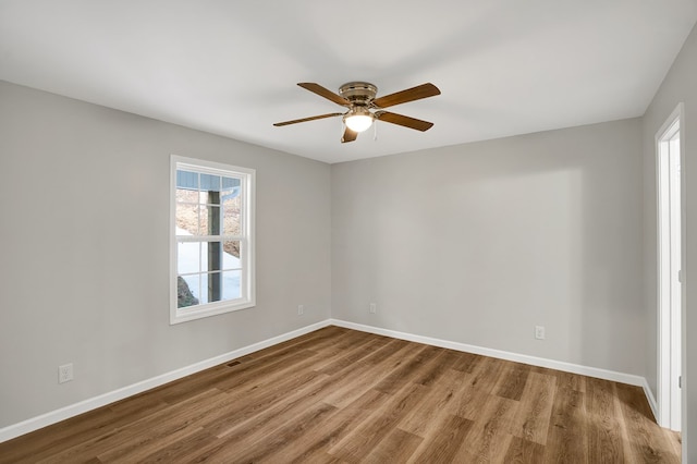 empty room featuring wood-type flooring and ceiling fan