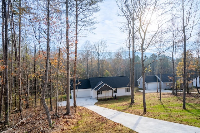 view of front of home with a garage and a front yard