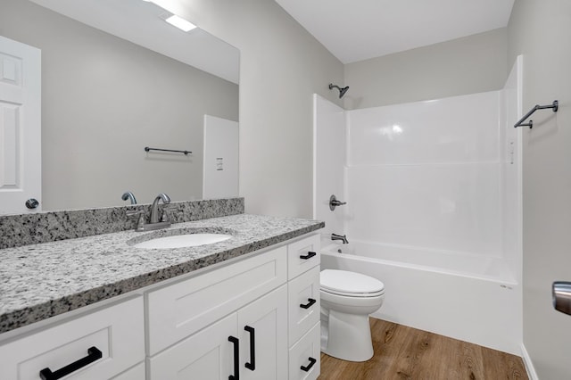 full bathroom with hardwood / wood-style flooring, vanity, toilet, and  shower combination