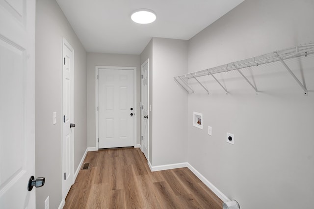 washroom featuring hardwood / wood-style floors, hookup for a washing machine, and hookup for an electric dryer