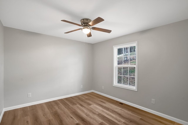 spare room with hardwood / wood-style flooring and ceiling fan