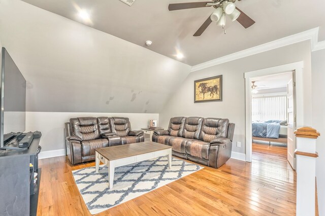 living room featuring ceiling fan, ornamental molding, lofted ceiling, and light hardwood / wood-style floors