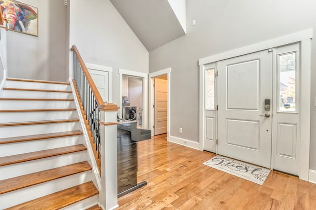 entryway featuring light hardwood / wood-style flooring and high vaulted ceiling