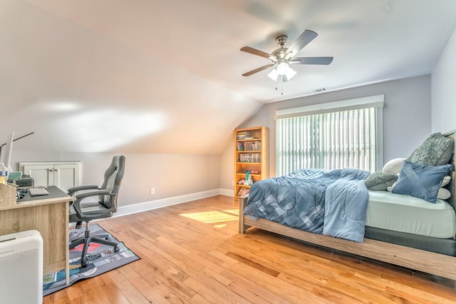 bedroom featuring vaulted ceiling, hardwood / wood-style floors, and ceiling fan