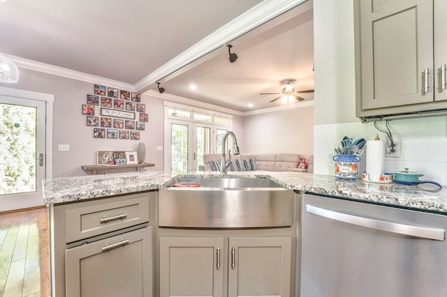 kitchen featuring dishwasher, sink, ornamental molding, light stone countertops, and french doors