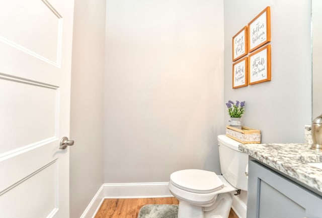 bathroom with vanity, hardwood / wood-style flooring, and toilet