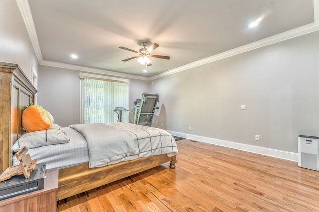 bedroom with ceiling fan, ornamental molding, and light hardwood / wood-style floors