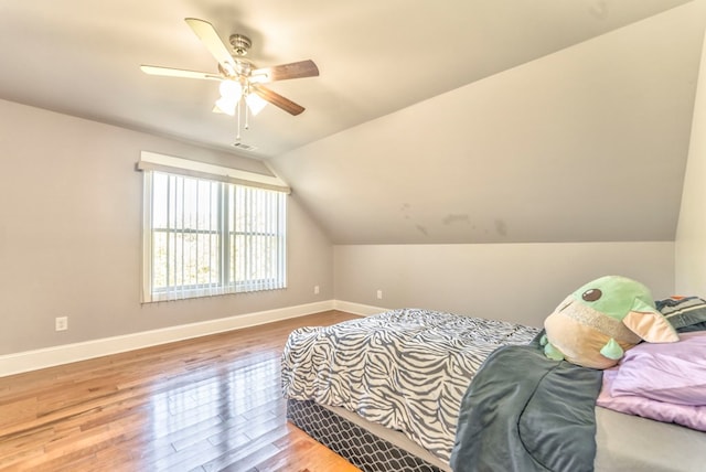 bedroom featuring vaulted ceiling, hardwood / wood-style floors, and ceiling fan