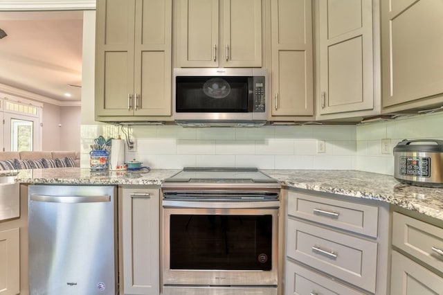 kitchen featuring light stone countertops, appliances with stainless steel finishes, ornamental molding, and decorative backsplash