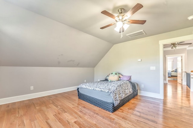 bedroom featuring vaulted ceiling, ceiling fan, and light wood-type flooring