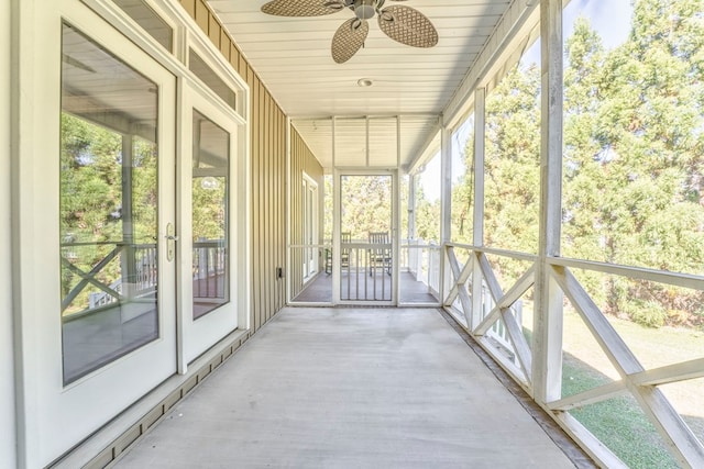 unfurnished sunroom with ceiling fan