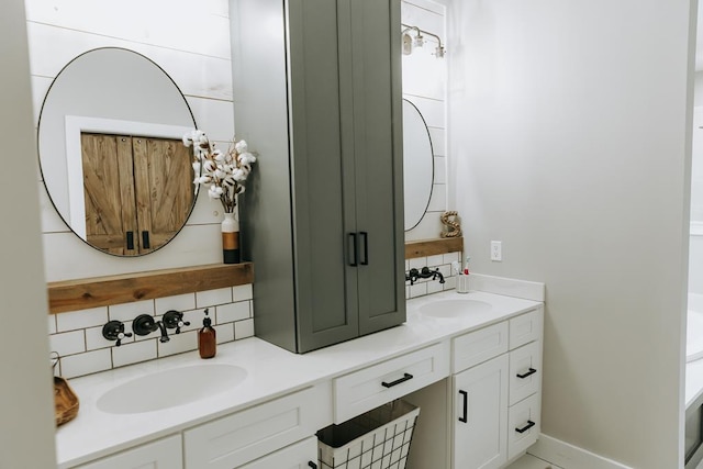 full bathroom with a sink, double vanity, and backsplash