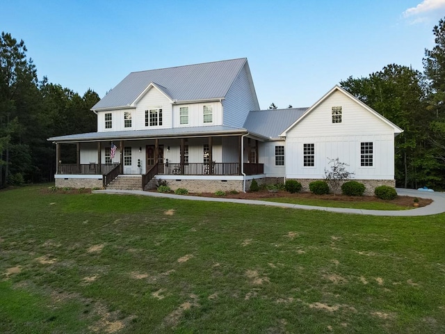 view of front of house with a front yard, board and batten siding, and metal roof