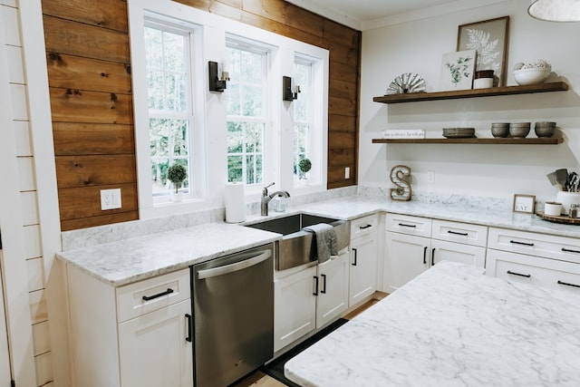 kitchen with light stone counters, a healthy amount of sunlight, a sink, and dishwasher
