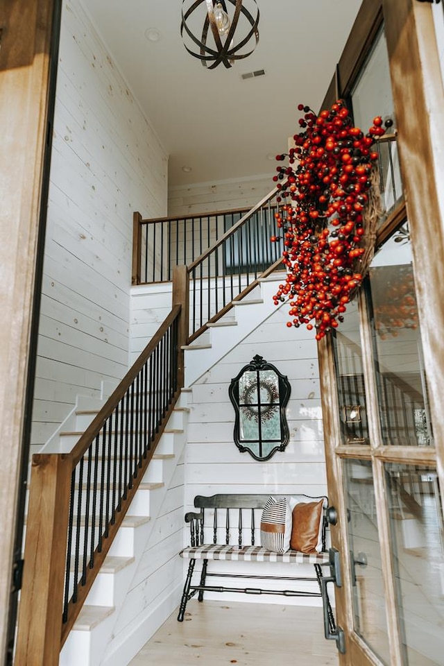 stairway featuring visible vents and wood finished floors
