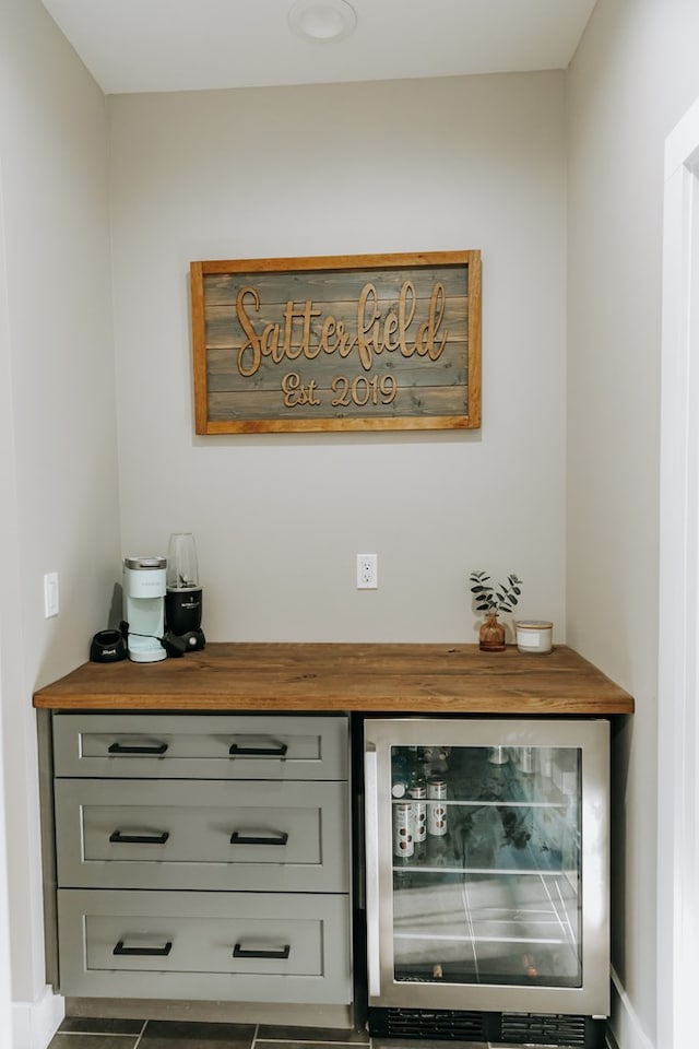 bar with baseboards and beverage cooler