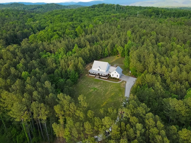 birds eye view of property featuring a mountain view and a view of trees
