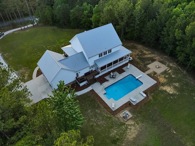 drone / aerial view with a wooded view