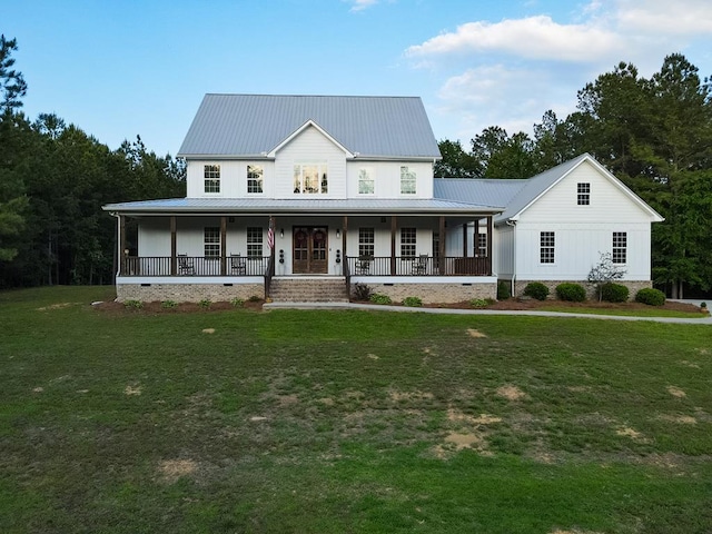 view of front facade featuring a front lawn, board and batten siding, a porch, and metal roof