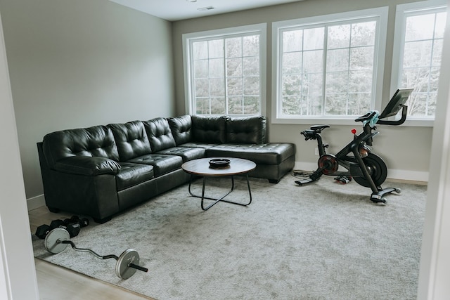 carpeted living room featuring baseboards and visible vents