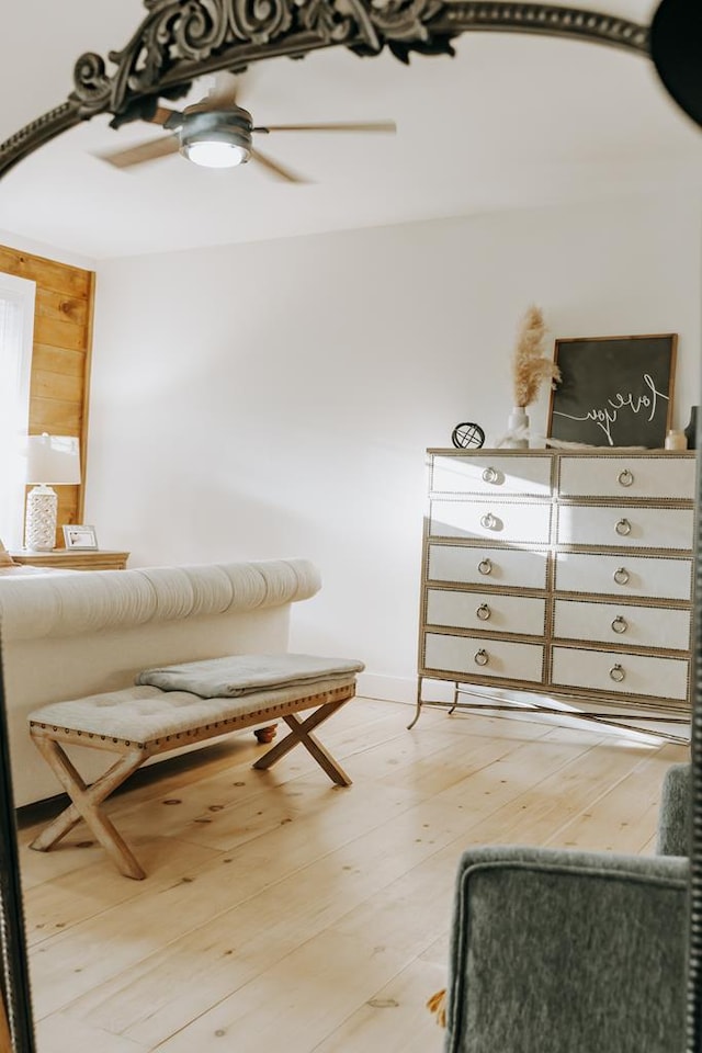 sitting room with a ceiling fan and wood finished floors