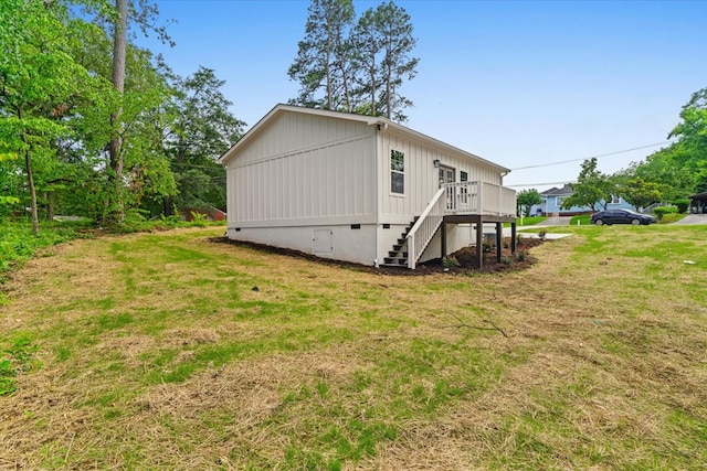 500 Woodland Dr, Dalton, GA 30721 - view of home's exterior featuring stairway, a wooden deck, a lawn, and board and batten siding
