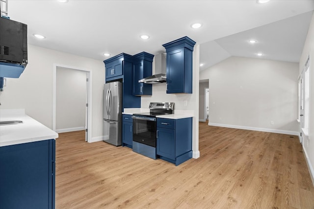 500 Woodland Dr, Dalton, GA 30721 - kitchen with stainless steel appliances, wall chimney exhaust hood, blue cabinets, light countertops, and light wood finished floors