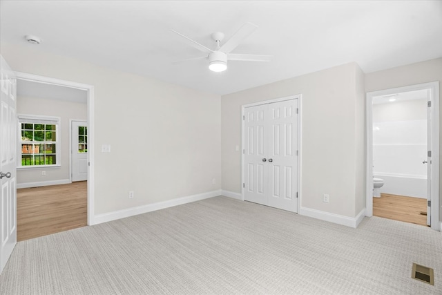 500 Woodland Dr, Dalton, GA 30721 - unfurnished bedroom featuring light carpet, a closet, ensuite bath, and a ceiling fan