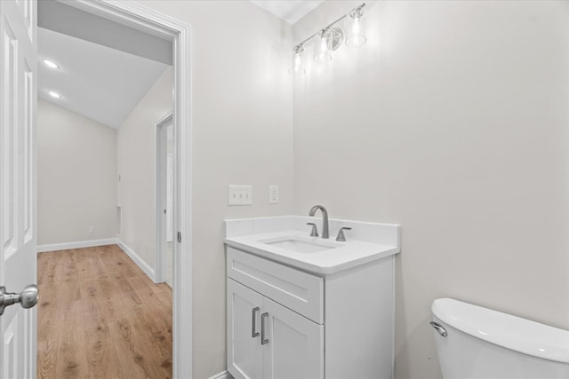 500 Woodland Dr, Dalton, GA 30721 - half bath featuring wood finished floors, vanity, and vaulted ceiling