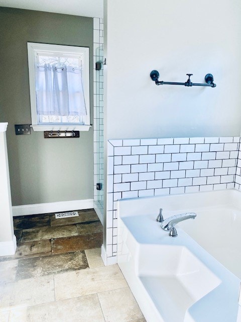 bathroom featuring a tub