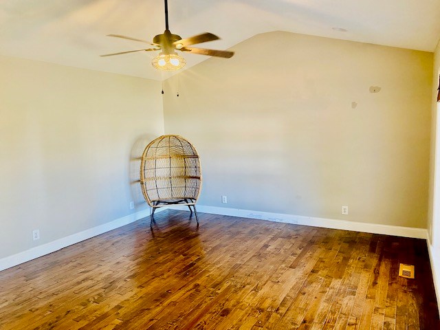 unfurnished room with vaulted ceiling, ceiling fan, and hardwood / wood-style floors