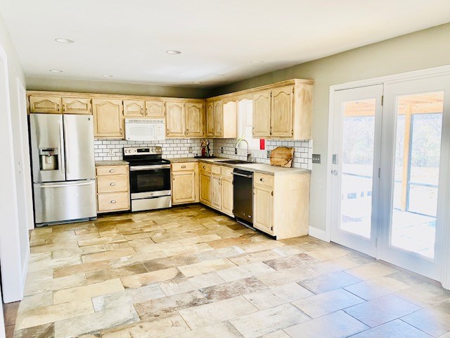 kitchen featuring tasteful backsplash, stainless steel appliances, sink, and light brown cabinets